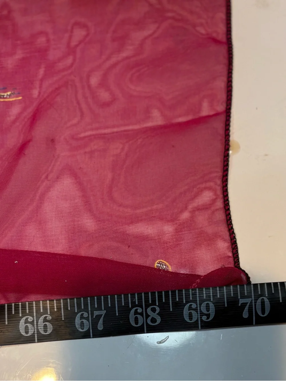 magenta and black scarf features palm tree motifs and black tassels along the ed